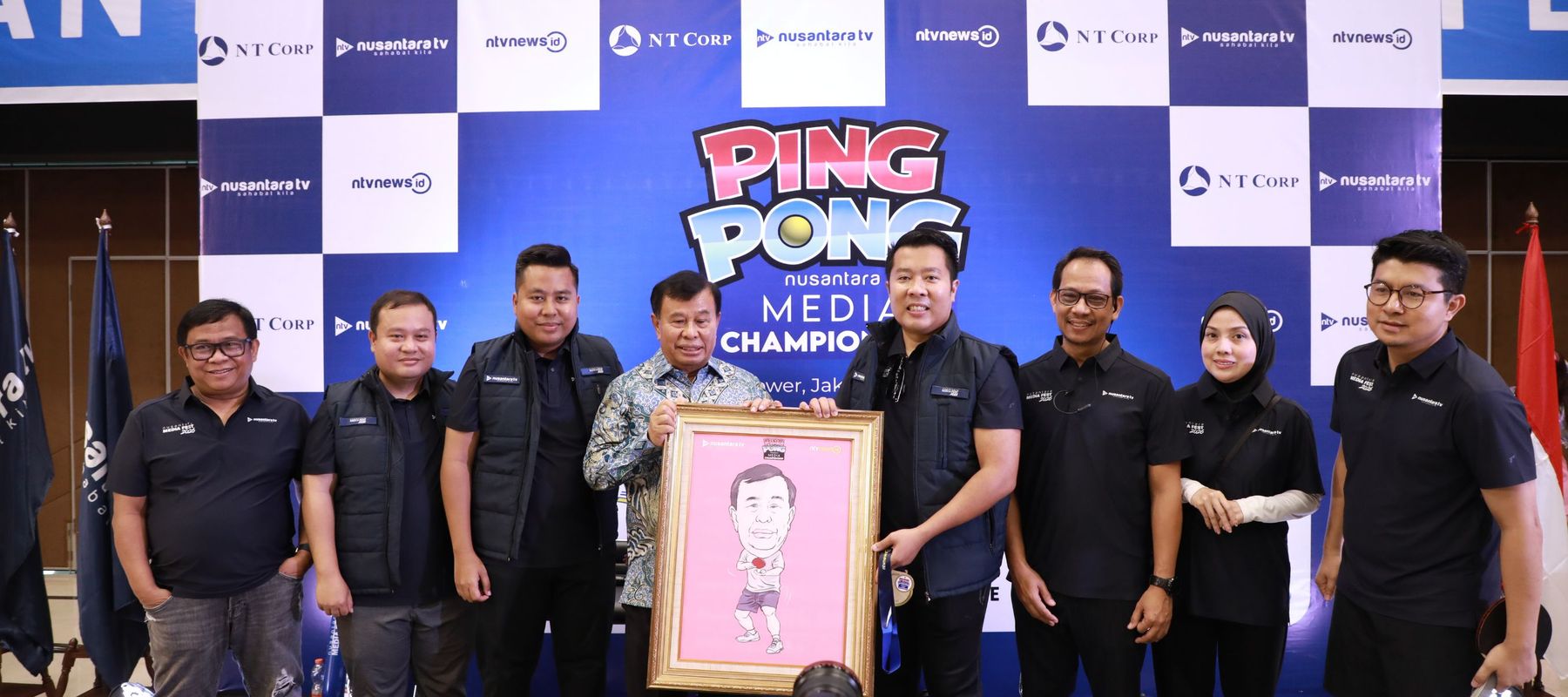 Direktur Utama Nusantara TV Randy Tampubolon memberikan karikatur kepada Presiden Komisaris NT Corp Nurdin Tampubolon di acara Nusantara Media Fest