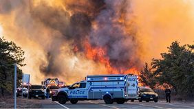 Kebakaran hutan yang terjadi di Long Island, New York, Amerika Serikat, meluas dengan cepat akibat angin kencang. Kobaran api yang tidak terkendali ini menghanguskan sebagian besar lahan, memicu kepulan asap dan abu tebal yang membumbung ke langit.