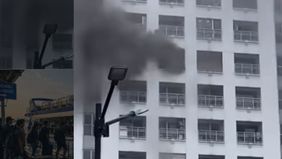 Evakuasi warga apartemen berjalan dramatis, sejumlah penghuni apartemen turun melalui tangga yang sudah disiapkan oleh petugas damkar di sisi luar gedung.