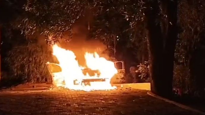 Mobil polisi yang dibakar massa. 