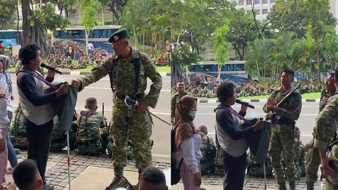 Anggota TNI menunjukkan kepedulian dan dukungan kepada seorang pengamen disabilitas.