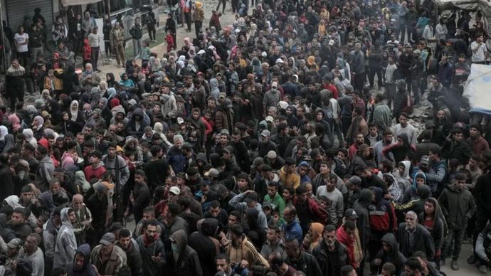 Kerumunan orang-orang terlihat saat mereka mengantre untuk membeli roti di sebuah toko roti di kota Khan Younis, Jalur Gaza selatan, pada 18 November 2024.