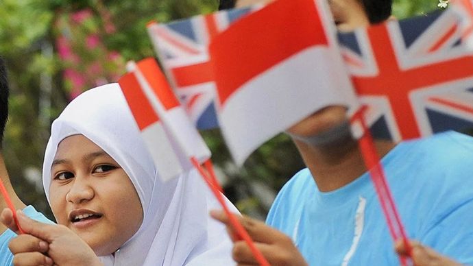 Ilustrasi - Sejumlah siswa mengibarkan bendera Indonesia dan bendera Inggris. 