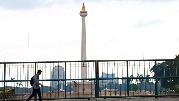 Warga saat berjalan di kawasan sekitar Monas Jakarta, Jumat (17/1/2025).