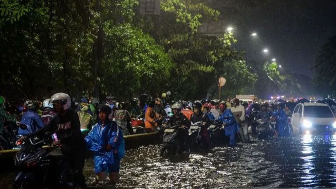 Sejumlah pengendara motor menuntun motornya melewati banjir di Jalan Daan Mogot, Cengkareng, Jakarta, Selasa (28/1/2025). Banjir setinggi 50 sentimeter akibat tingginya intensitas hujan tersebut membuat sejumlah kendaraan mogok dan lalu lintas jalan  <b>(ANTARA (Putra M. Akbar))</b>