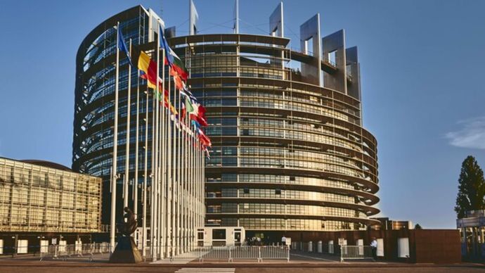 European Parliament building in Strasbourg, France with a clear blue sky in the background