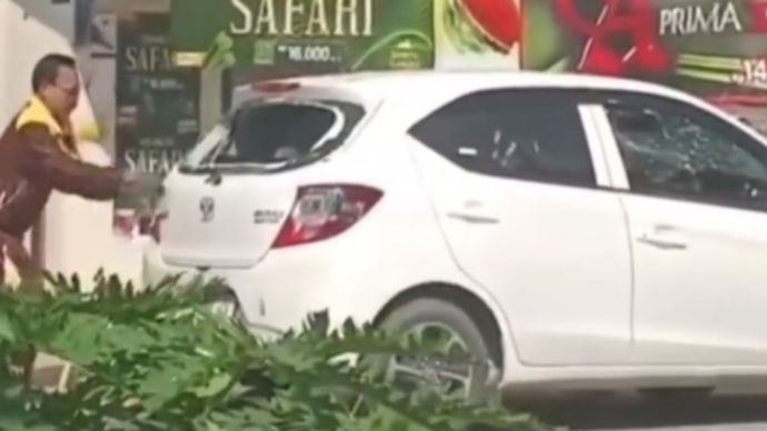 Pria hancurkan mobil sendiri. 