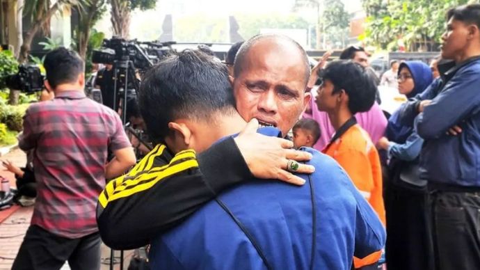 Seorang ayah memeluk anaknya yang akhirnya dipulangkan Polda Metro Jaya usai ditangkap saat aksi di depan gedung DPR/MPR RI, Selasa (26/8/2025). 