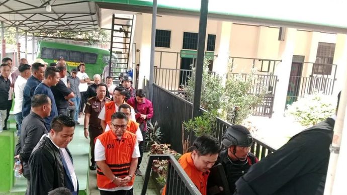 Mantan Bupati Koltim Abd Azis (depan) bersama tiga terdakwa lainnya akan memasuki ruang sidang di PN Kendari, Sulawesi Tenggara, Selasa, 13 Januari 2026. ANTARA/La Ode Muh Deden Saputra