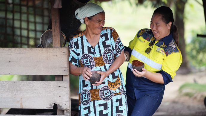 Dua perempuan menunjukkan produk olahan hasil lokal di area produksi sederhana, mencerminkan komitmen PT Merdeka Copper Gold Tbk dalam pemberdayaan masyarakat dan praktik keberlanjutan yang turut mendukung capaian peringkat ESG &ldquo;A&rdquo; dari MSCI selama tiga tahun berturut-turut.