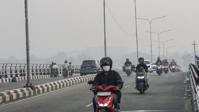 Sejumlah pengendara melintas di atas jembatan Siak IV yang dipenuhi kabut asap di Pekanbaru, Riau, Senin, 24 Agustus 2026. Pemerintah Provinsi Riau menghimbau kepada masyarakat untuk mengurangi aktivitas di luar ruang serta menggunakan masker kesehat