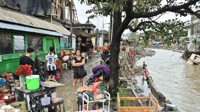 Warga berjalan di dekat bangunan rumah terdampak banjir di kawasan Jalan Bukit Barisan, Denpasar, Bali, Rabu 10 September 2025. ANTARA FOTO/Fikri Yusuf/rwa.