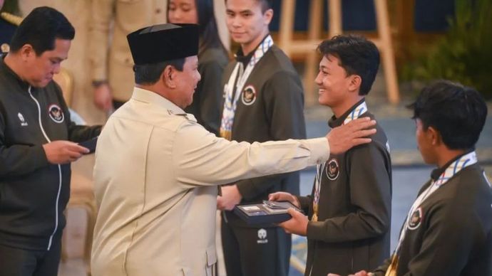 Presiden Prabowo Subianto (kedua kiri) didampingi Menpora Erick Thohir (kiri) menyerahkan buku tabungan kepada atlet skateboard Basral Graito (kedua kanan) saat penyerahan bonus kepada atlet peraih medali pada SEA Games Thailand di Istana Negara, Jak